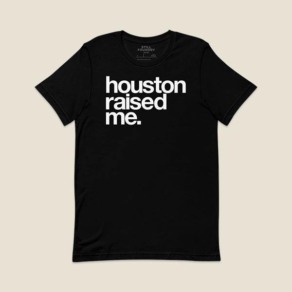 Black t-shirt with bold text on the front that reads "houston raised me" in white.