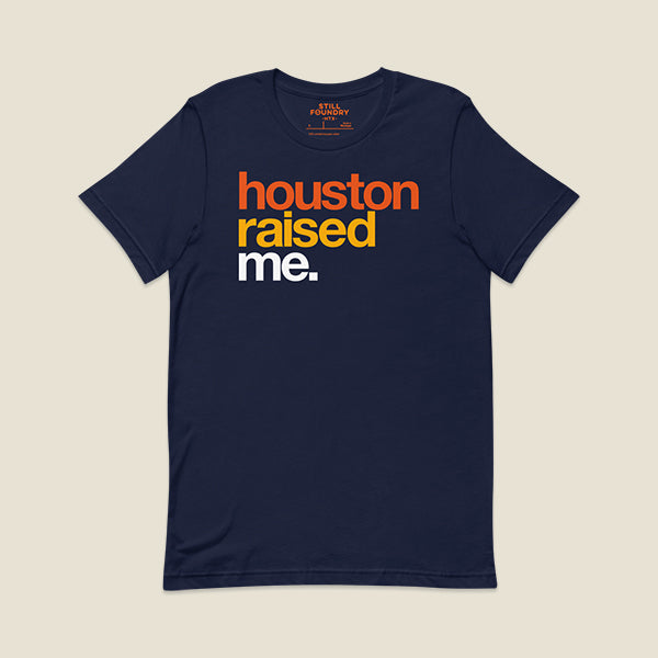 Navy blue t-shirt with bold, colorful text on the front that reads "houston" in orange, "raised" in yellow, and "me." in white.