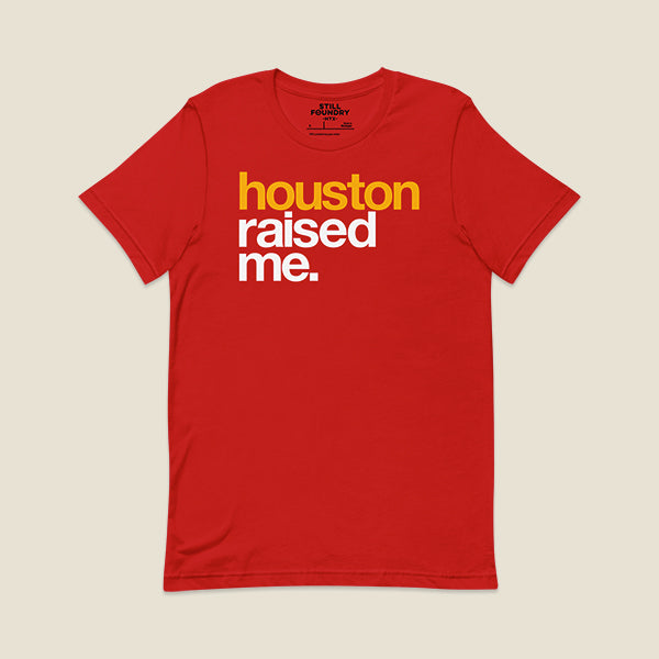 Red t-shirt with bold, colorful text on the front that reads "houston" in yellow, "raised me." in white.