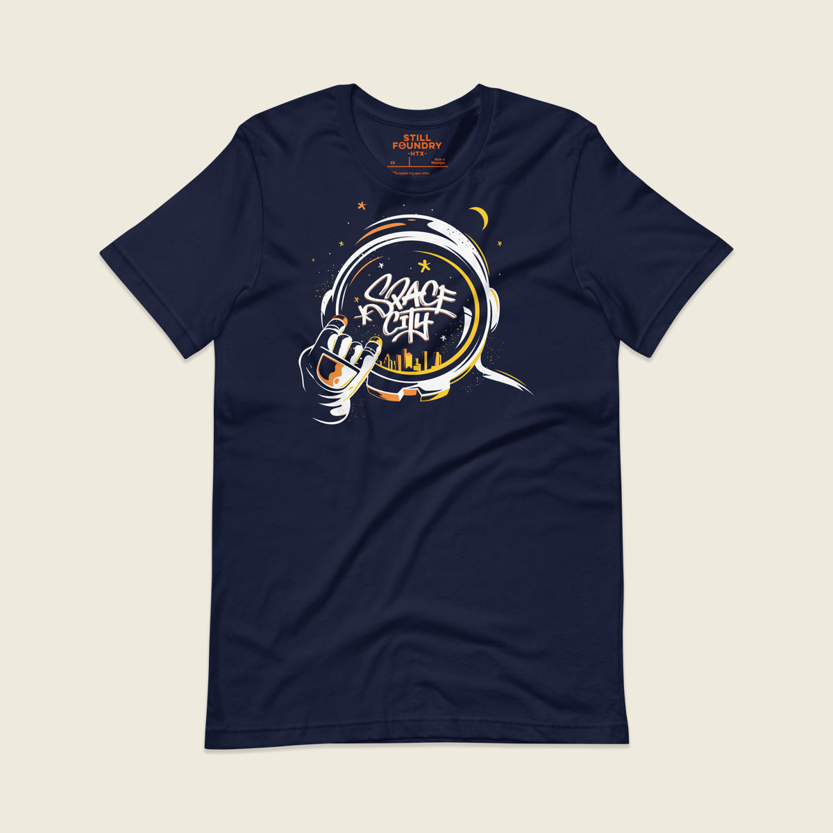 Navy t-shirt featuring an illustrated astronaut holding up the H-Town hand sign, with the word “Space City” written in graffiti-style lettering inside the astronaut’s helmet and a yellow Houston skyline reflected below, surrounded by stars and a crescent moon.