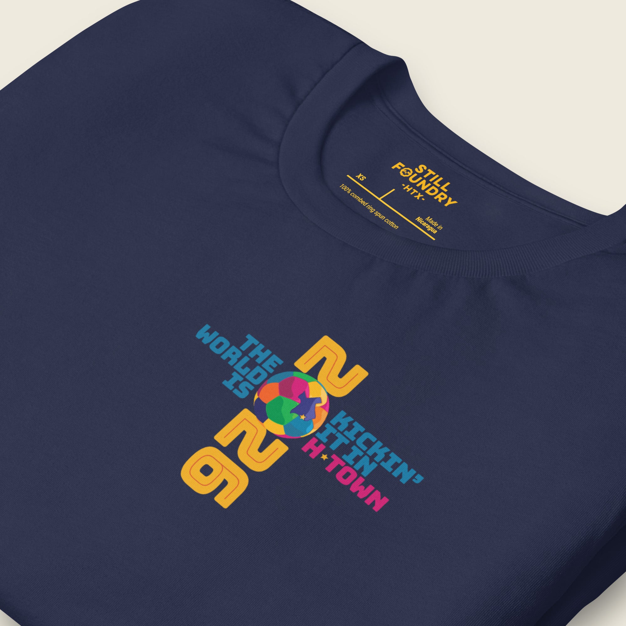 Folded navy Houston T-shirt showing 2026 graphic and “Kickin’ It in H-Town” front design.