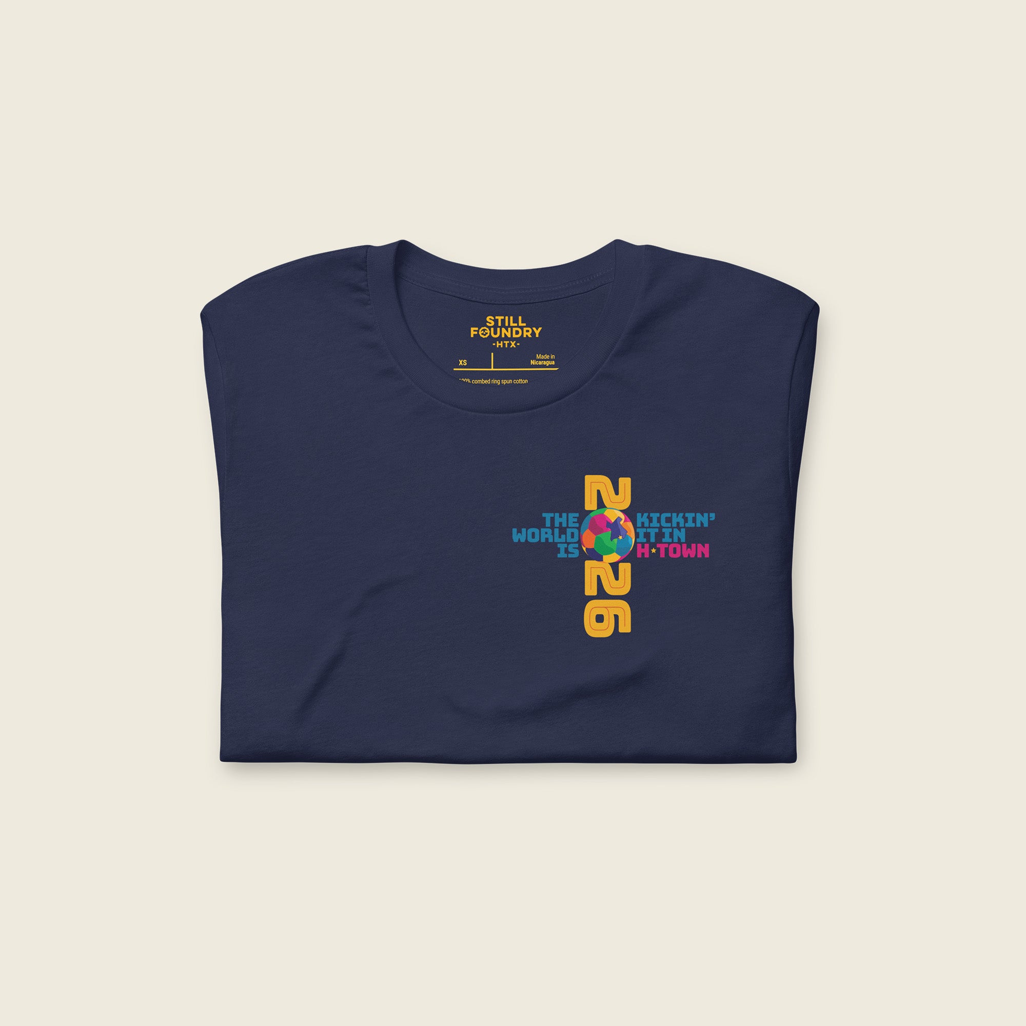 Folded navy Houston T-shirt showing 2026 graphic and “Kickin’ It in H-Town” front design.