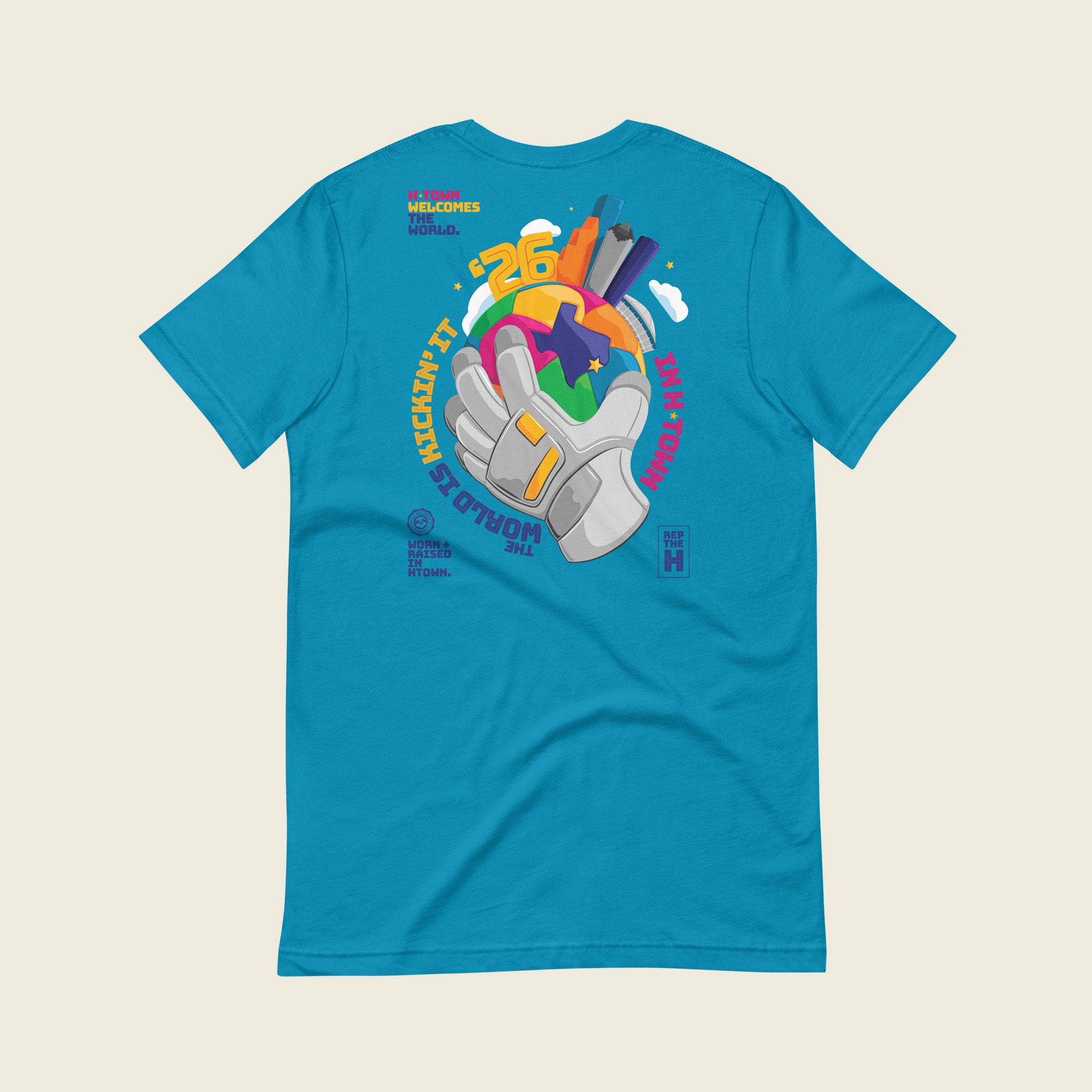 Back of aqua Houston 2026 T-shirt with colorful globe graphic and “Kickin’ It in H-Town” design.