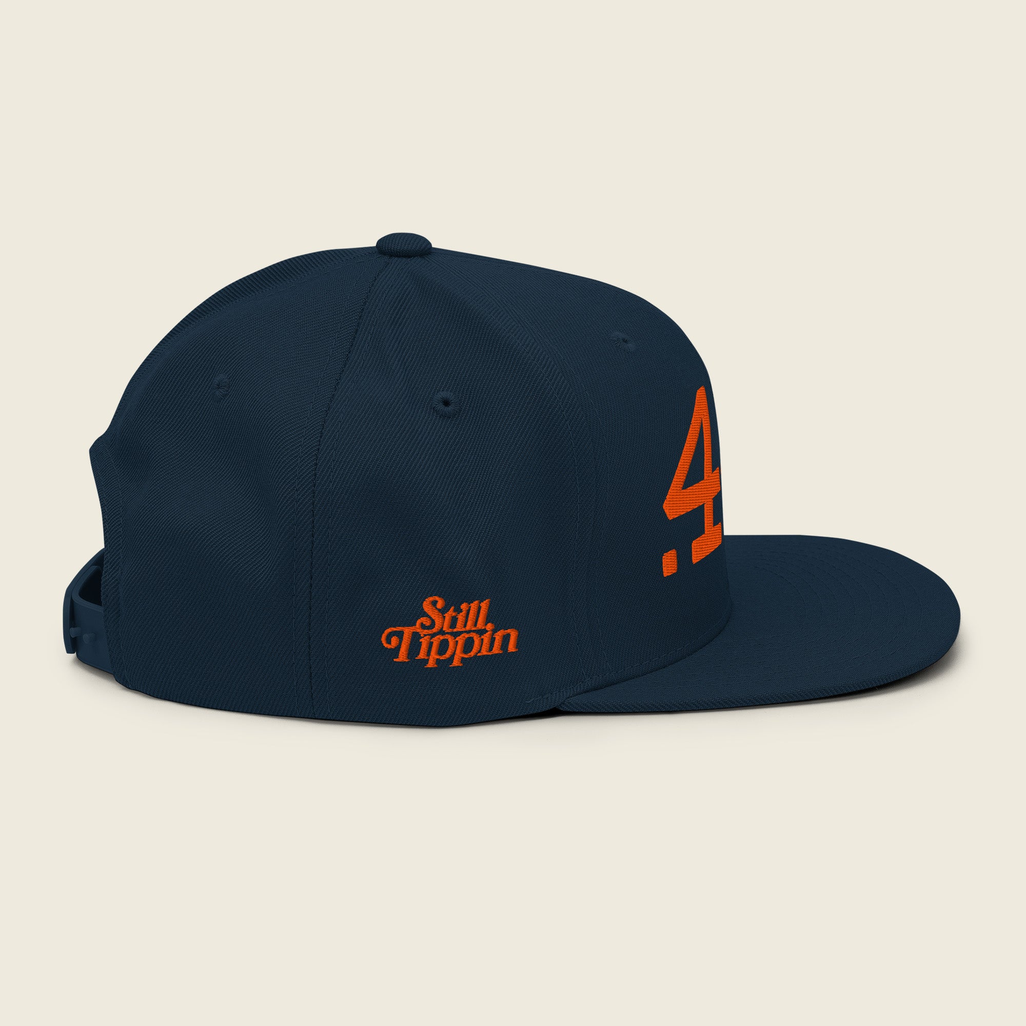 Side view of Still Tippin .44s snapback hat with Still Tippin embroidery and adjustable snapback closure.