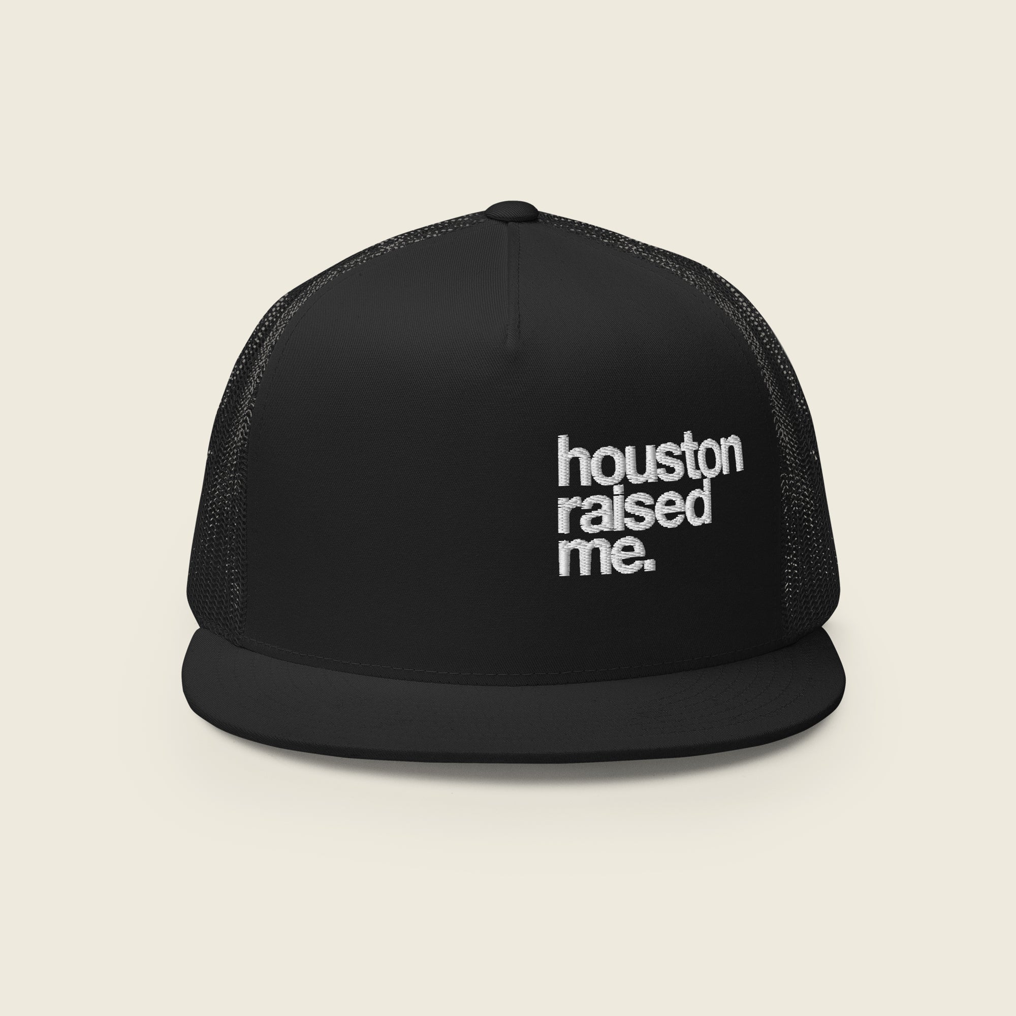 Black trucker snapback hat, front panel and flat bill visible; embroidered, stacked text at right-front reads “houston raised me.” (white).