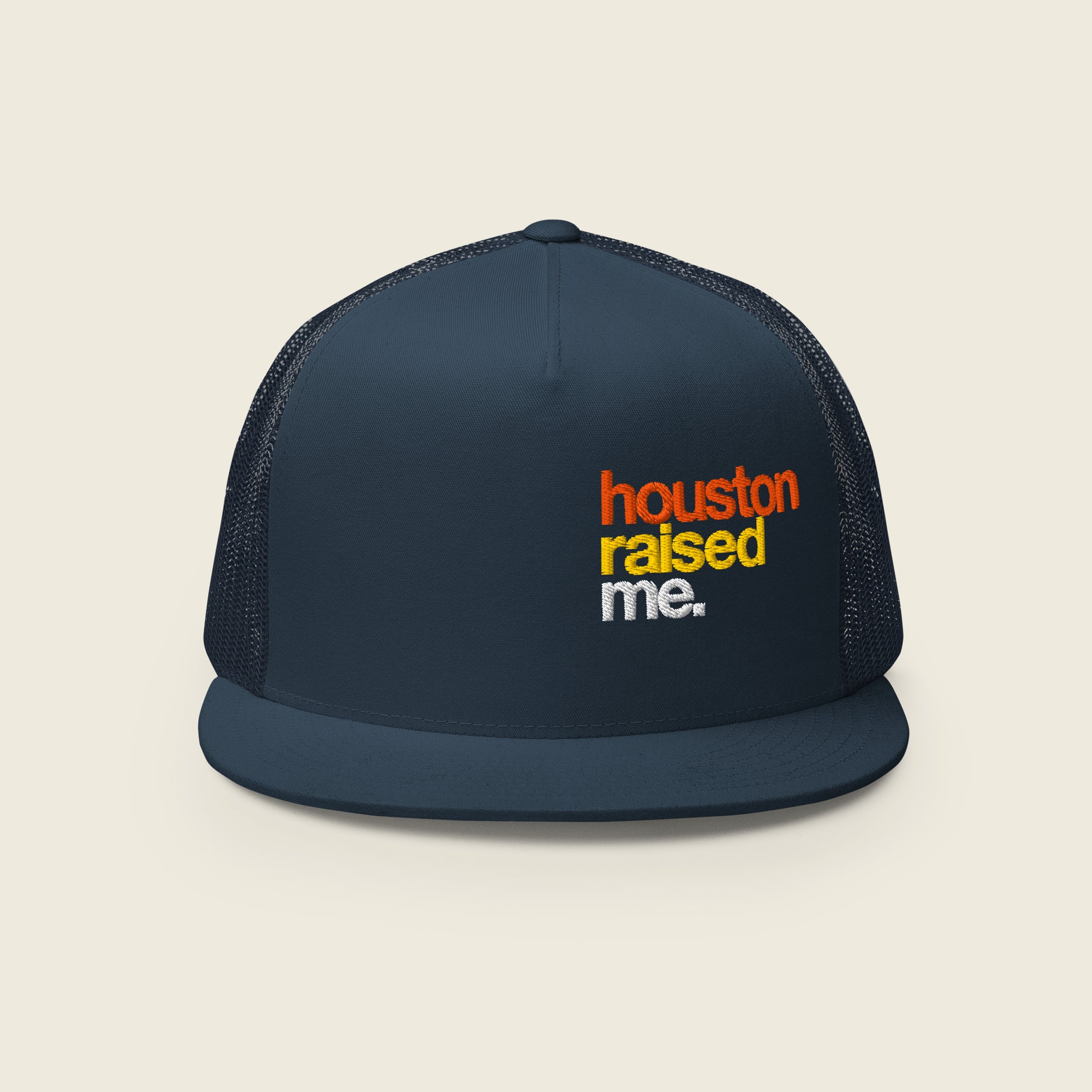 Navy trucker snapback hat, front panel and flat bill visible; embroidered, stacked text at right-front reads “houston” (orange), “raised” (yellow), “me.” (white).