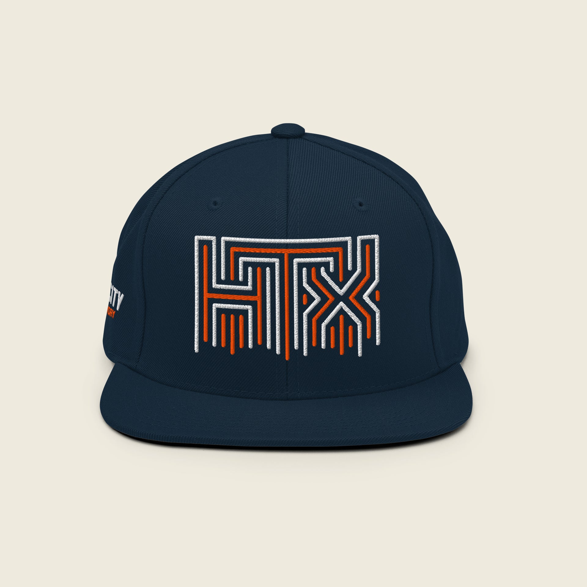 Navy Houston snapback hat with embroidered HTX logo in orange and white front view.