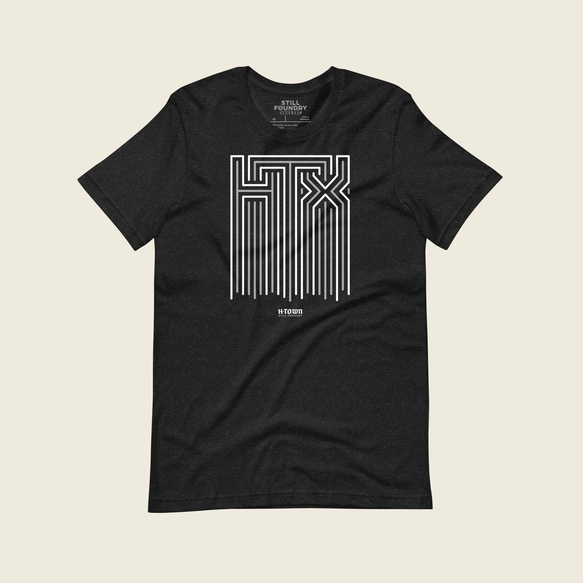 Black short-sleeve t-shirt laid flat with a large geometric neon sign “HTX” graphic in white and gray on the chest and the words “HTOWN” printed below in small white old english letters.